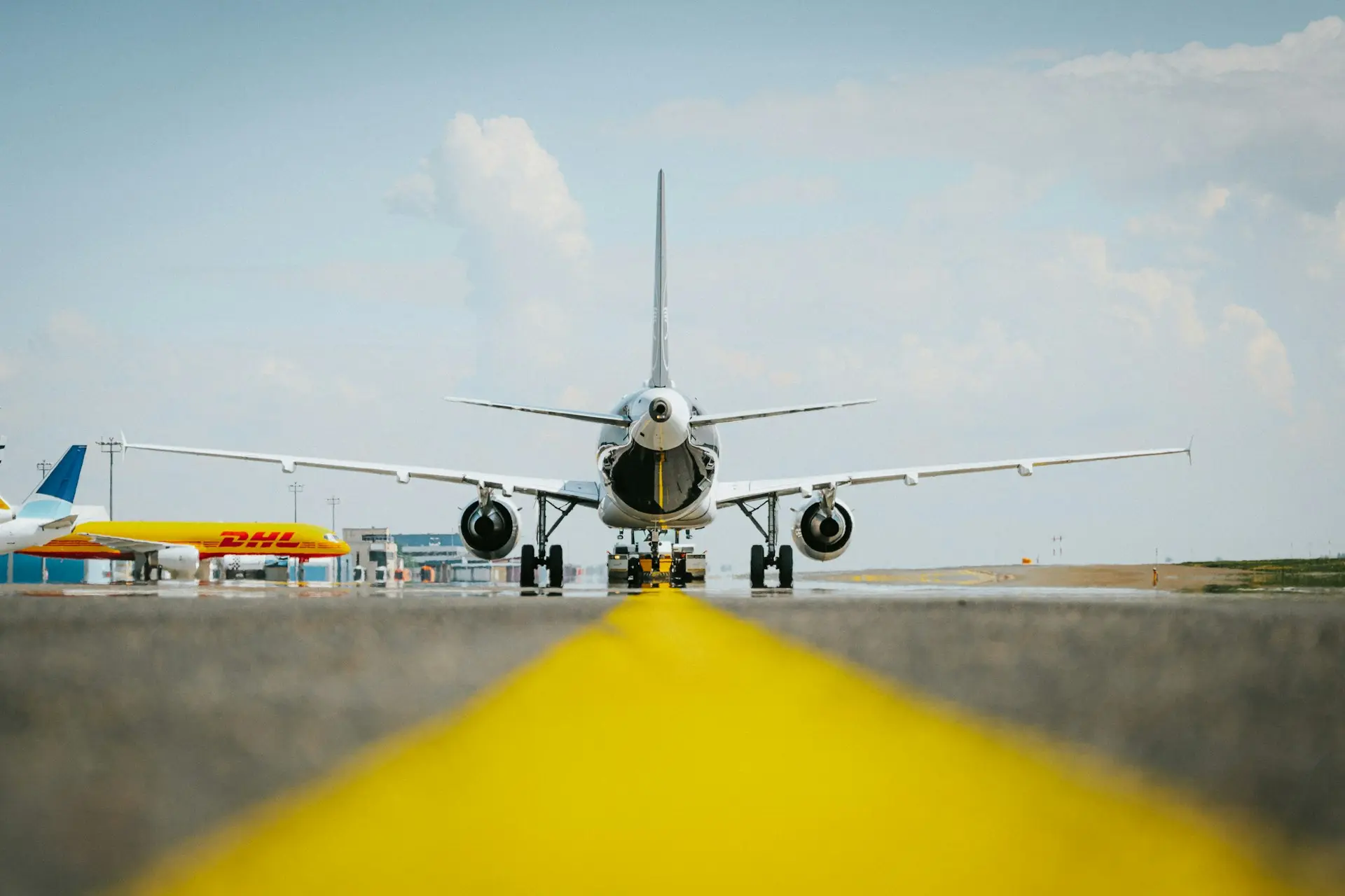 a large jetliner sitting on top of an airport runway